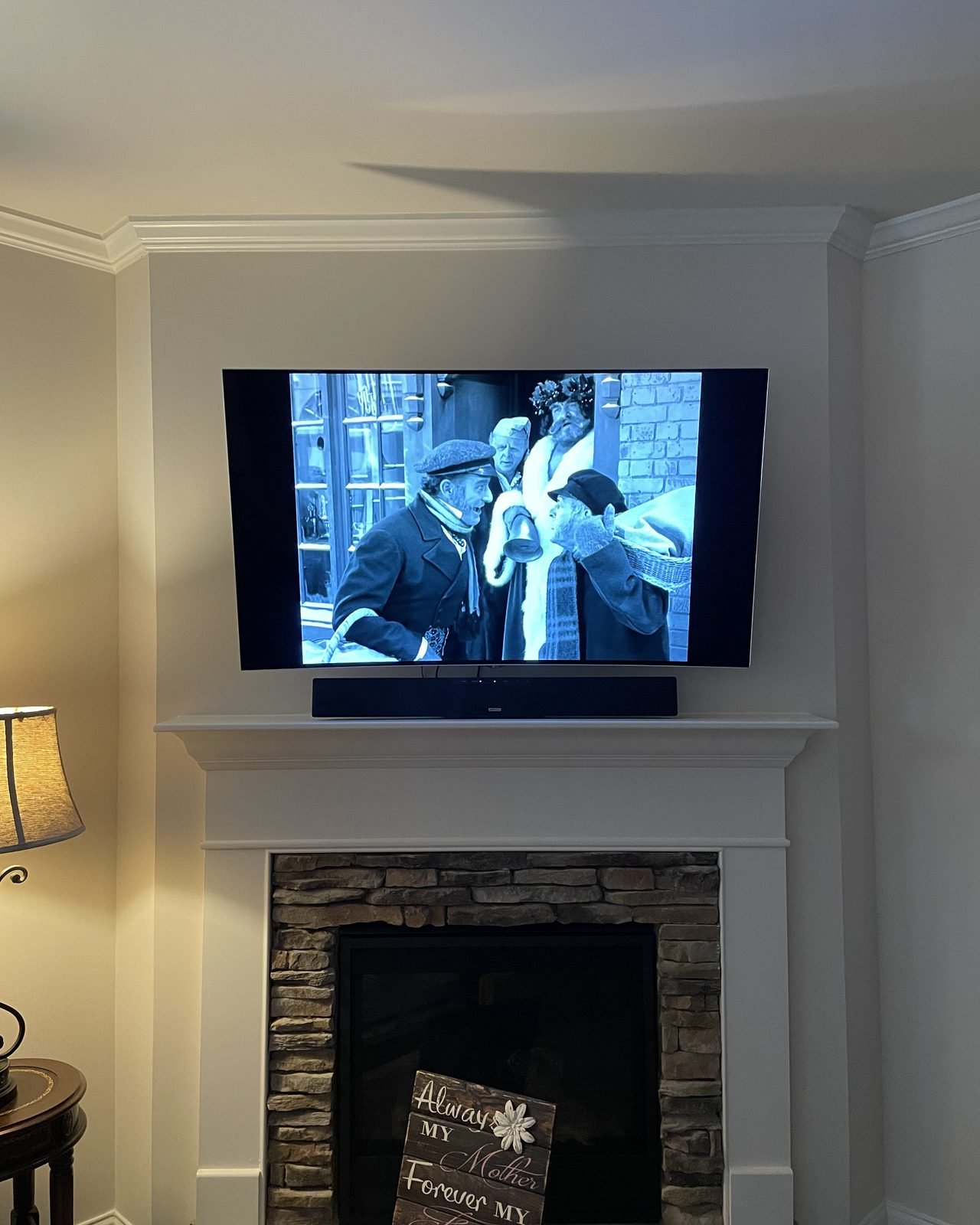 Flat screen TV wall-mounted above a media console